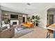 Comfortable living room featuring a white fireplace, decorative shelves, ceiling fan, and large tile flooring at 6542 Lake Pembroke Pl, Orlando, FL 32829