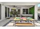Relaxing covered patio with a hot tub, dining table, and stylish decor for ultimate outdoor living at 6542 Lake Pembroke Pl, Orlando, FL 32829