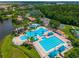 Aerial view of community pool with slide, splash pad, lounge chairs, and an Olympic-sized pool at 6542 Lake Pembroke Pl, Orlando, FL 32829