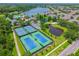 Aerial view of the community tennis courts, located close to the community pool and lake at 6542 Lake Pembroke Pl, Orlando, FL 32829