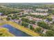 Aerial view of a neighborhood featuring a lake with surrounding trees and nearby highway at 6702 Imperial Oak Ln, Orlando, FL 32819