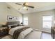 Staged bedroom with a large bed, neutral tones, and ample natural light from multiple windows at 6702 Imperial Oak Ln, Orlando, FL 32819