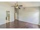 Large bedroom with wood floors featuring high ceilings and a ceiling fan and access to the bathroom at 6702 Imperial Oak Ln, Orlando, FL 32819