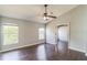 Bright bedroom with wood floors, a ceiling fan, and plenty of natural light from two windows at 6702 Imperial Oak Ln, Orlando, FL 32819