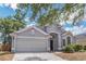 Stylish single-story home with a large garage and well-maintained landscaping at 6702 Imperial Oak Ln, Orlando, FL 32819