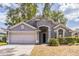Charming single-story home with a well-manicured lawn and attached two-car garage at 6702 Imperial Oak Ln, Orlando, FL 32819