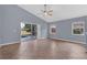 Bright living room with a ceiling fan, a sliding glass door leading to the pool, and neutral decor at 6702 Imperial Oak Ln, Orlando, FL 32819
