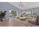 Comfortable living room with a ceiling fan, a sliding glass door leading to the pool, and cozy furniture at 6702 Imperial Oak Ln, Orlando, FL 32819
