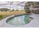 Relaxing screened-in pool offers a private outdoor retreat with views of the surrounding landscape at 6702 Imperial Oak Ln, Orlando, FL 32819