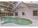 Backyard pool with screened enclosure and adjacent patio area at 6702 Imperial Oak Ln, Orlando, FL 32819