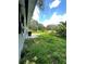 Exterior shot of the backyard featuring a small patio and an expansive grassy area at 732 Trenton Rd, Lakeland, FL 33815