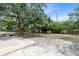 Large backyard with mature trees and a concrete patio at 7741 Pine Hollow Ct, Orlando, FL 32822