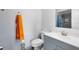 Clean bathroom with gray vanity, updated fixtures, mirror, and tiled shower at 7741 Pine Hollow Ct, Orlando, FL 32822