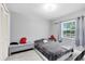 Simple bedroom featuring a closet, window, and tiled floors at 7741 Pine Hollow Ct, Orlando, FL 32822