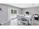 Bright dining room with a patio door and wood-look tile flooring at 7741 Pine Hollow Ct, Orlando, FL 32822