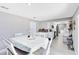 Open concept dining area with neutral walls, and wood-look tile flooring connecting to the kitchen at 7741 Pine Hollow Ct, Orlando, FL 32822