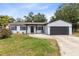 Charming single-story home with white brick, dark trim, and a cozy hanging chair on the front porch at 7741 Pine Hollow Ct, Orlando, FL 32822