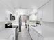 Modern kitchen featuring white cabinets, stainless steel appliances, and wood-look tile flooring at 7741 Pine Hollow Ct, Orlando, FL 32822