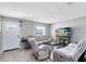 Bright living room with wood-look tile, neutral walls, comfortable seating, and a front door at 7741 Pine Hollow Ct, Orlando, FL 32822