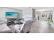Inviting living room features neutral tones, wood-look tile flooring, comfortable seating, and a modern TV at 7741 Pine Hollow Ct, Orlando, FL 32822