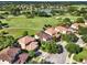 A stunning aerial shot features beautiful homes alongside a scenic golf course and a serene lake, creating a tranquil setting at 8150 Prestbury Dr, Orlando, FL 32832