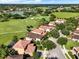A beautiful view of homes set beside a lush golf course and a shimmering lake, offering an ideal blend of nature and luxury at 8150 Prestbury Dr, Orlando, FL 32832