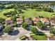Stunning aerial view of a home nestled in a golf course community with lake views and beautiful landscaping at 8150 Prestbury Dr, Orlando, FL 32832
