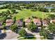 A scenic aerial view showcases beautiful homes lining a lush green golf course with a picturesque lake nearby at 8150 Prestbury Dr, Orlando, FL 32832