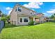 Home exterior showing lawn, black metal fence and covered patio at 8150 Prestbury Dr, Orlando, FL 32832