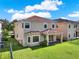 Exterior of home showcasing backyard with green lawn, patio and neutral colored stucco at 8150 Prestbury Dr, Orlando, FL 32832