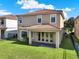 Exterior of home showcasing backyard with green lawn, patio and neutral colored stucco at 8150 Prestbury Dr, Orlando, FL 32832