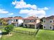 Exterior home view showcases a backyard with well-manicured lawn, fence, and covered patio at 8150 Prestbury Dr, Orlando, FL 32832