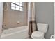 Bathroom showcasing a bathtub with tiled walls, shower, and a toilet at 8150 Prestbury Dr, Orlando, FL 32832