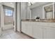 Bathroom featuring a double vanity with granite countertops and tiled floors at 8150 Prestbury Dr, Orlando, FL 32832