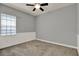 Bedroom boasts a ceiling fan, neutral color scheme, and natural light from the window at 8150 Prestbury Dr, Orlando, FL 32832
