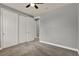 Bedroom with neutral color palette, ceiling fan, and closet with double doors at 8150 Prestbury Dr, Orlando, FL 32832