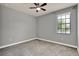 Bedroom features neutral colored walls, carpet, and a window bringing in natural light at 8150 Prestbury Dr, Orlando, FL 32832