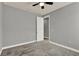Neutral bedroom featuring gray carpet, a ceiling fan and an open door way at 8150 Prestbury Dr, Orlando, FL 32832