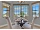 Bright breakfast nook features a table set for four and a large window with serene outdoor views at 8150 Prestbury Dr, Orlando, FL 32832