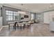 Open dining room with modern chandelier, electric fireplace, neutral colors, and large windows at 8150 Prestbury Dr, Orlando, FL 32832