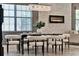 Dining room with modern chandelier, electric fireplace, neutral colors, and views to outdoor area at 8150 Prestbury Dr, Orlando, FL 32832