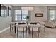 Elegant dining room with a modern chandelier, fireplace, and neutral decor providing a sophisticated ambiance at 8150 Prestbury Dr, Orlando, FL 32832