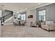 Dining room with adjacent living area featuring modern decor, fireplace, and large windows at 8150 Prestbury Dr, Orlando, FL 32832