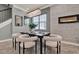 Dining room features modern chandelier, neutral colors, fireplace, and views to outdoor area at 8150 Prestbury Dr, Orlando, FL 32832