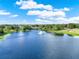 Picturesque lake view with a fountain and nearby golf course creating a serene community ambiance at 8150 Prestbury Dr, Orlando, FL 32832