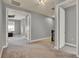 Upstairs landing with multiple doorways and neutral carpet flooring, offering access to different areas of the home at 8150 Prestbury Dr, Orlando, FL 32832