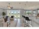 Bright living room with golf course views, tile floors, and comfortable seating with access to outdoor patio at 8150 Prestbury Dr, Orlando, FL 32832