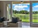 Bright living room showcasing golf course views through sliding glass doors, with comfortable seating at 8150 Prestbury Dr, Orlando, FL 32832