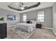 Serene main bedroom featuring a tray ceiling, plush carpet, and stylish furnishings at 8150 Prestbury Dr, Orlando, FL 32832