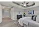 Bright and airy main bedroom features a tray ceiling, stylish decor, and comfortable furnishings at 8150 Prestbury Dr, Orlando, FL 32832